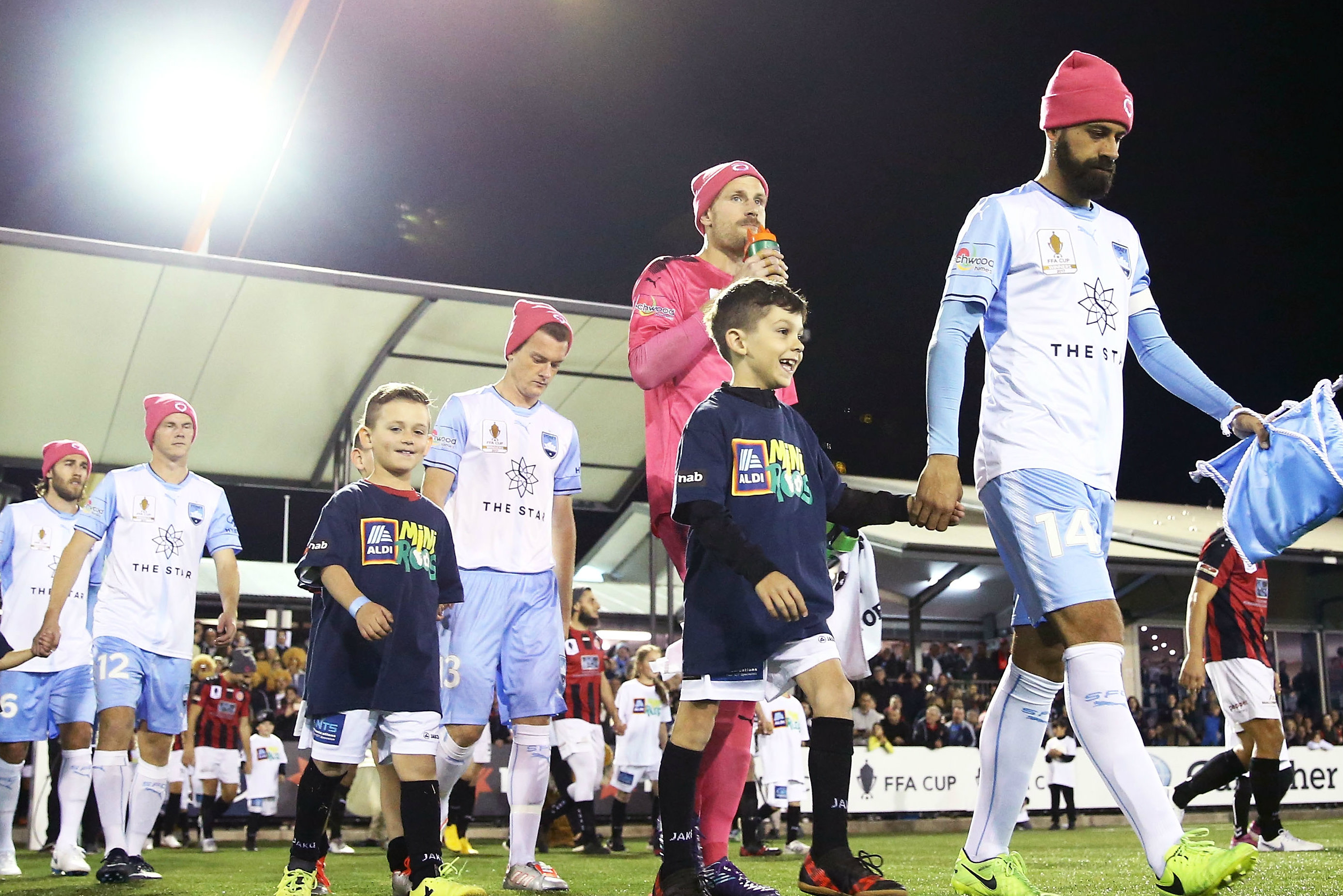 Sydney FC players wear the Donate Life beanies onto the pitch against Rockdale City.