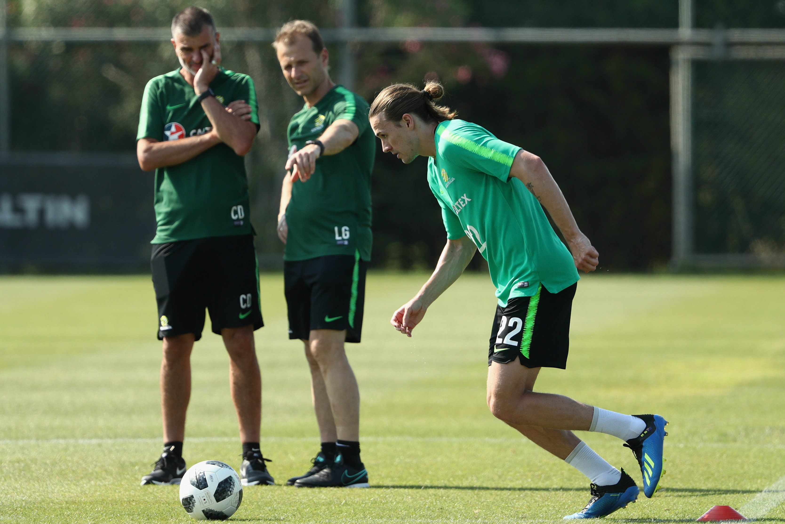 Craig Duncan and Les Gelis look on at Jackson Irvine during Socceroos training.